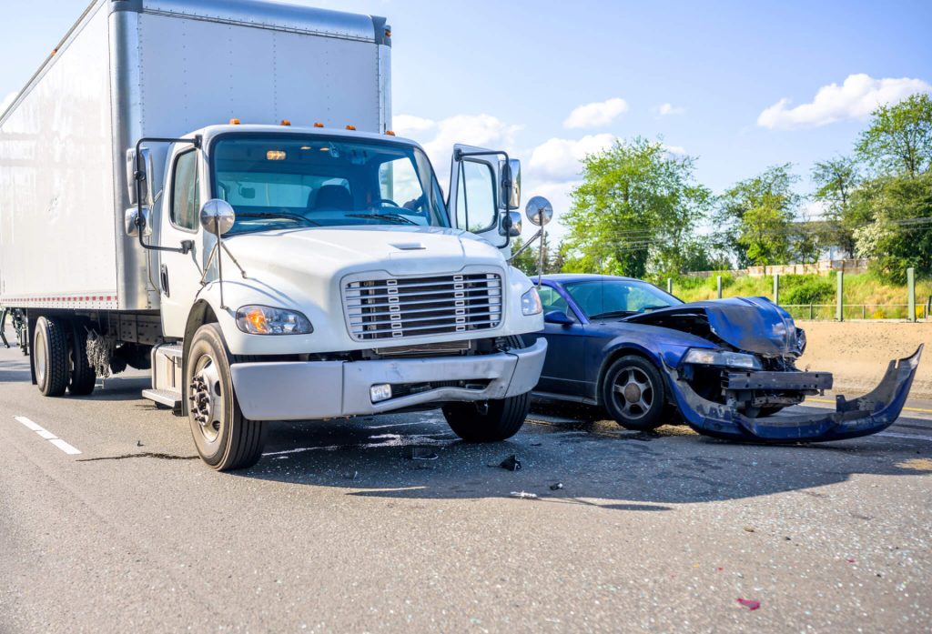 Box truck and car damaged after a collision
