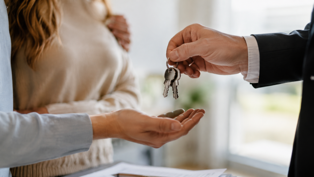 Real estate agent handing house keys to a buyer