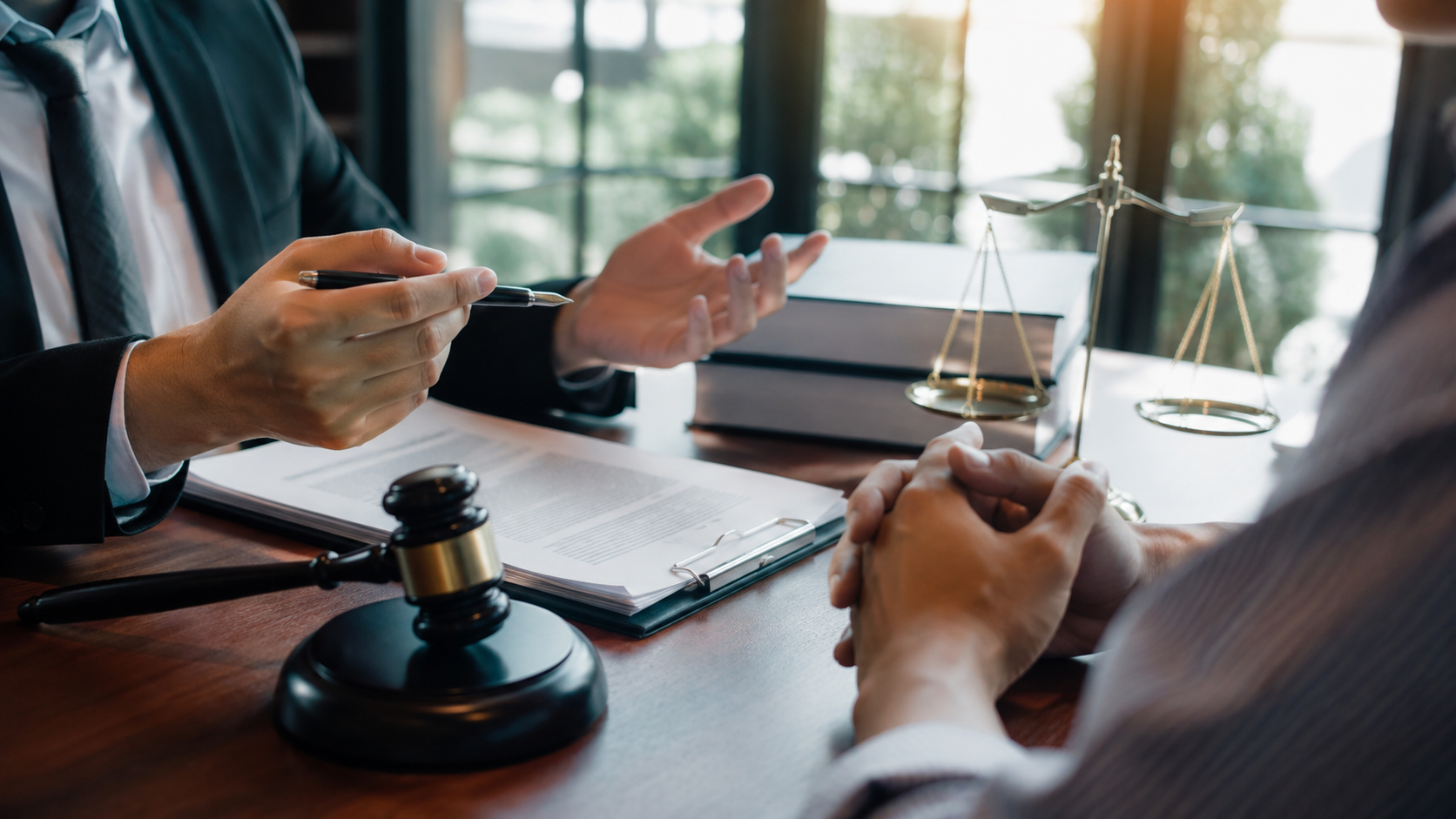Attorney and client discussing a lawsuit at a desk
