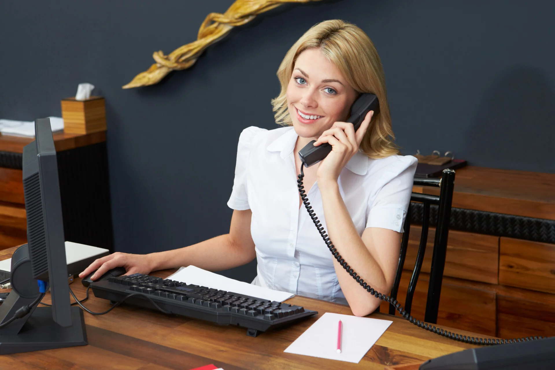 Receptionist answering a phone call at a law office front desk