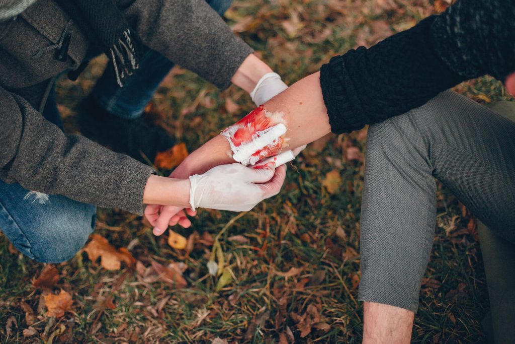 Person providing first aid to an injured arm